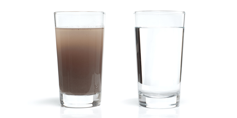 Two glasses of water, one with dirty water and the other with clean water