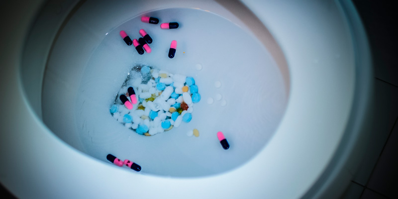 Toilet bowl filled with pills