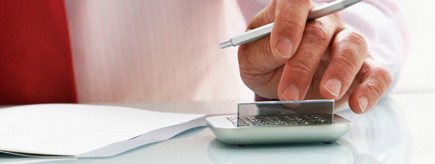 Accountant professional at desk with pen and calculator