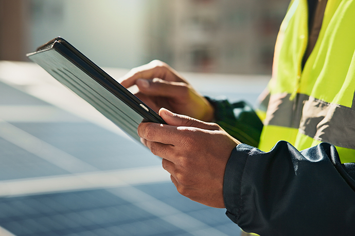Laptop, tablet and collaboration with business people at night in the office together for teamwork. Technology, smile and a happy employee team of women working on a project or report in the evening