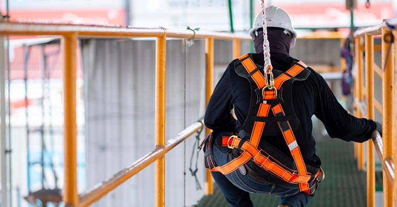 Construction worker using fall protection