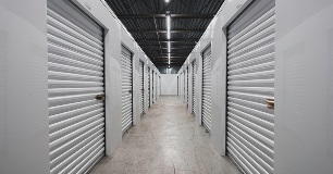 A self storage facility with multiple garages lining the walls.