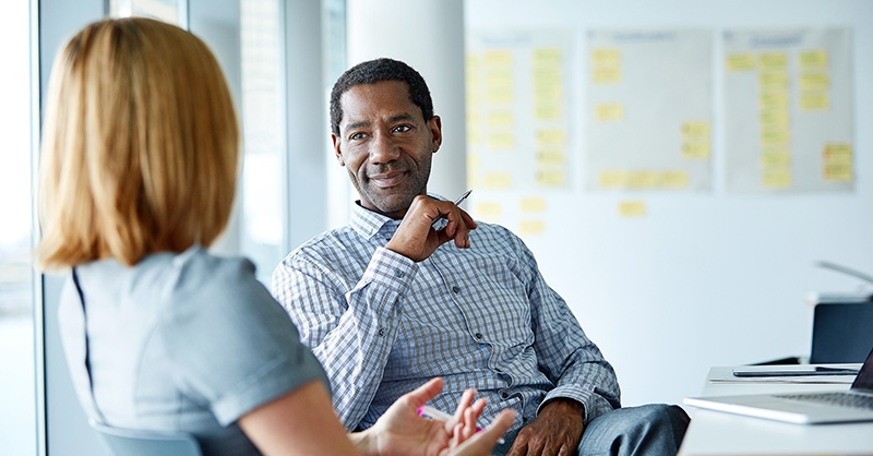 Male and female meeting in large conference room
