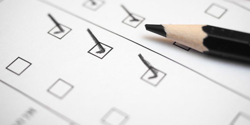 Black marking on checklist box with pencil close up